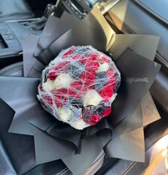 a red, white and black object sitting on top of a piece of cloth in a car