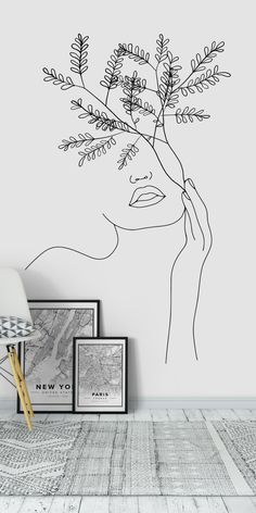 a drawing of a woman's face with flowers in her hair on the wall