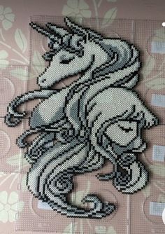 an image of a cross stitch pattern of a unicorn on a pink and white background