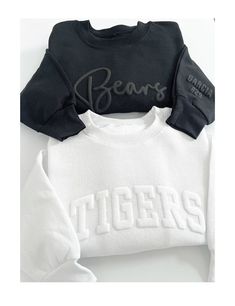 two sweatshirts with the word bears on them, one in black and one in white