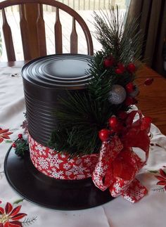 a christmas hat on top of a table with red and white ribbon around the rim