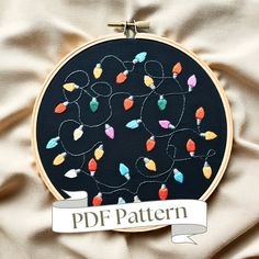 an embroidery pattern with lights on it and a ribbon that says pdf pattern in the center