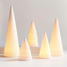 three white lamps are sitting next to each other