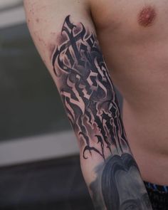 a man with a cross tattoo on his arm