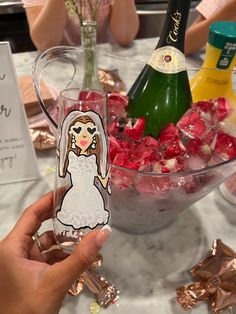 a person holding a wine glass in front of a bowl of candy