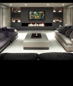 a living room filled with furniture and a flat screen tv mounted to the side of a wall