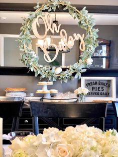 a table topped with white flowers next to a mirror