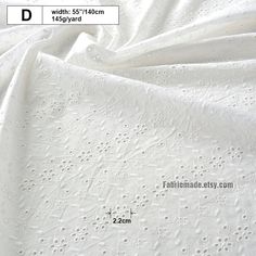 an image of white fabric with small dots on the bottom and center, as well as measurements