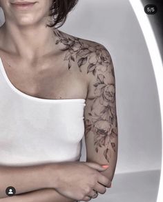 a woman with tattoos on her arm and shoulder