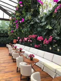 an image of a restaurant with flowers on the wall and tables in front of it