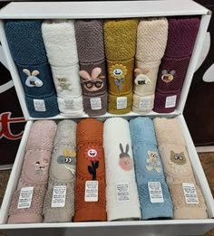 a display case filled with lots of different colored towels in it's packaging boxes