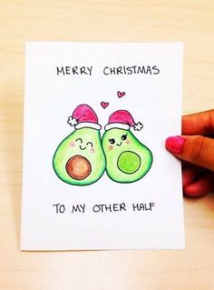 someone is holding up a christmas card with two avocados on it and the words merry christmas to my other half