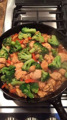 chicken and broccoli stir frying in a skillet on the stove top