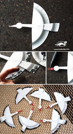 some paper plates and spoons are being made to look like spaceships on the ground