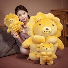 a woman is holding two stuffed animals on the bed