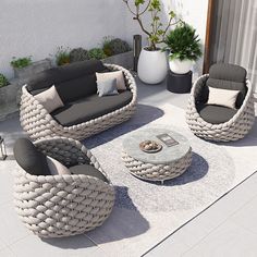 an outdoor living room with wicker furniture and potted plants