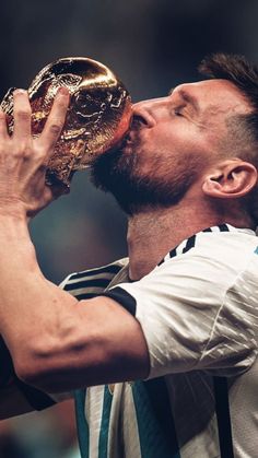 a man drinking from a golden trophy in his mouth