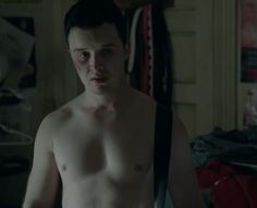 a shirtless man with no shirt standing in a room