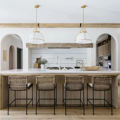 a kitchen with an island and four chairs