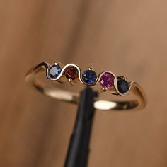 It is a multi stone silver band,delicate stacking ring . The main stone is 2.5 mm round cut. Lab Sapphire / Garnet / Lab Ruby The basic metal is sterling silver plated with rhodium. To change the metal to a solid gold (white/yellow /rose) or platinum is also available, please ask for a quotation if you want. You can also go to my shop Home for more elegant rings: https://www.etsy.com/shop/godjewelry?ref=hdr_shop_menu More rings: https://www.etsy.com/shop/godjewelry?ref=l2-shop-header-avatar Cust 14k Gold Multi-stone Stackable Rings, 14k Gold Multi-stone Stackable Rings For Anniversary, Rose Gold Stackable Rings With Birthstone, Multi-stone Stackable Rings For Promise, Multi-stone Stackable Promise Rings, Stackable Rose Gold Birthstone Ring With Round Band, 14k Gold Three Stone Stackable Rings For Anniversary, Stackable Rose Gold Birthstone Ring, Anniversary Multi-stone Birthstone Ring In Rose Gold