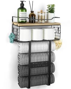 the bathroom shelf is organized with towels, soaps and toiletries on it's sides