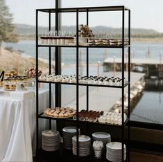 an assortment of pastries and desserts are on display in front of a window