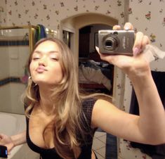 a woman taking a selfie in the bathroom