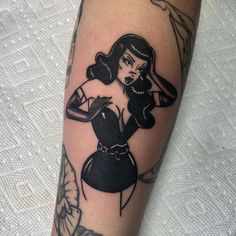 a woman's arm with a black and white tattoo design on the left forearm