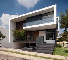 a modern house with stairs leading up to it