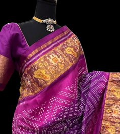 Expertly handwoven with pure zari, this Purple Patola Silk Bandhani Saree is a stunning addition to any wardrobe. Adorned with intricate bandhani patterns, this saree is a perfect blend of traditional and modern style. Comes with a stitched blouse for a complete and hassle-free look. Perfect for any occasion. Purple patola  silk  with  gold pallu with stitched blouse beautiful border. DETAILS AND CARE Colour : purple Weight : 600 - 800 grams Length : 5.5 m saree + 0.7 m blouse Width : 48 Inches Fabric : patola pure silk Craft Description : patola Wash Care : Dry Wash Only Shipping Time : 5 - 7 Working days We Ship Worldwide Comes with prestitched blouse size 36 goes up to 42 very beautiful high quality   silk saree  https://admin.shopify.com/store/shruthis-sarees/articles/559483519167   SH Traditional Slub Silk Blouse Piece With Bandhani Print, Slub Silk Pre-draped Saree With Bandhani Print For Puja, Slub Silk Bandhani Pre-draped Saree For Puja, Ikat Print Choli For Festivals With Traditional Drape, Traditional Drape Choli With Ikat Print For Festivals, Traditional Drape Ikat Print Choli For Festivals, Festival Ikat Print Choli With Traditional Drape, Banarasi Silk Ikat Print Saree For Wedding, Wedding Banarasi Silk Saree With Ikat Print