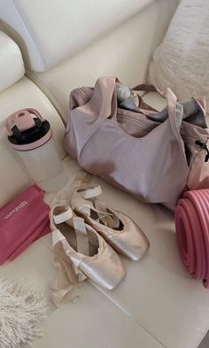 there are many items that can be found on the couch, including ballet shoes and a water bottle