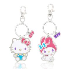 two hello kitty key chains are shown on a white background