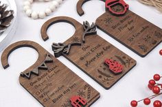 three wooden cutting boards with christmas designs on them and decorations in the shape of santa's sleighs