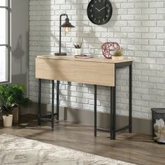 a table with a clock on the wall next to a window and potted plants