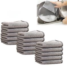 a stack of towels sitting on top of a sink next to a hand holding a strainer