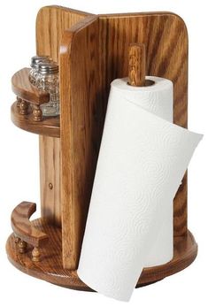 a wooden holder with two rolls of toilet paper on it and a roll of tissue