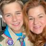 a young man and woman are posing for a photo with medals on their chests