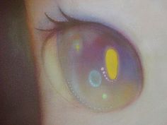 an eye with yellow and blue circles on it's irise, as seen from the side