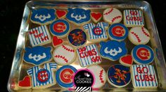 decorated cookies in the shape of baseballs and other sports related items on a tray