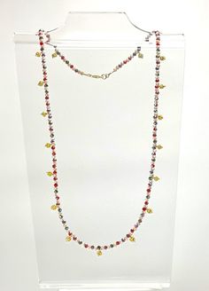 "I used an exotic style reminiscent of jewelry made in India.  This colorful and fun design was used to create this long (23\") necklace using small (3mm) round faceted AB (aurora borealis) sparkly glass beads in bright colors of red, light tan and black.  Interspersed are small, bright gold filled bicone granulated dangles.  The small lobster clasp is gold filled.  You can also wrap the necklace around your wrist several times to create a beautiful bracelet!" Multicolor Faceted Jewelry For Party, Multicolor Faceted Beads Dangle Necklaces, Multicolor Crystal Jewelry With Spacer Beads, Multicolor Dangle Necklaces With Faceted Beads, Faceted Round Bead Crystal Necklace For Party, Multicolor Crystal Beaded Chain Jewelry, Multicolor Crystal Beaded Chain Necklace, Adjustable Crystal Necklace For Festivals, Multicolor Lariat Necklaces For Party