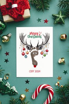 a christmas card with an image of a reindeer and candy canes next to it