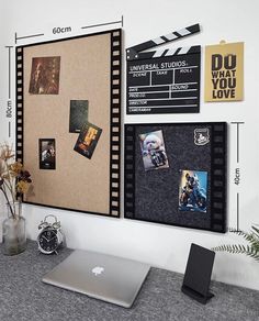 a laptop computer sitting on top of a desk next to a wall mounted projector