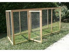 three wooden chicken coops in the grass