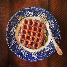 a waffle sitting on top of a blue and white plate