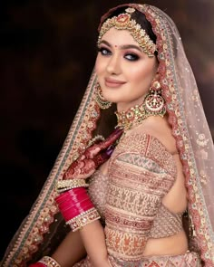 a woman in a bridal outfit posing for the camera