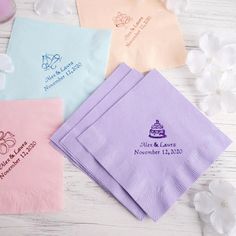 four personalized napkins on a table with flowers