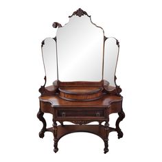 an antique vanity with three mirrors on it's sides and a drawer underneath the mirror