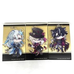 three keychains with anime characters on them sitting in front of a white background