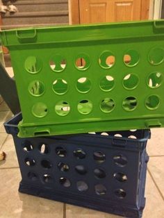 two blue and green baskets sitting on top of a tile floor next to each other