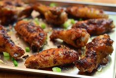 chicken wings with green onions on a tray